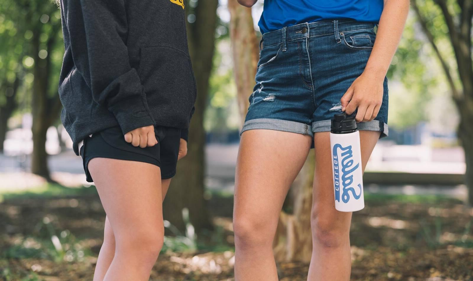 Photo of Salem College students legs with one student holding a water bottle