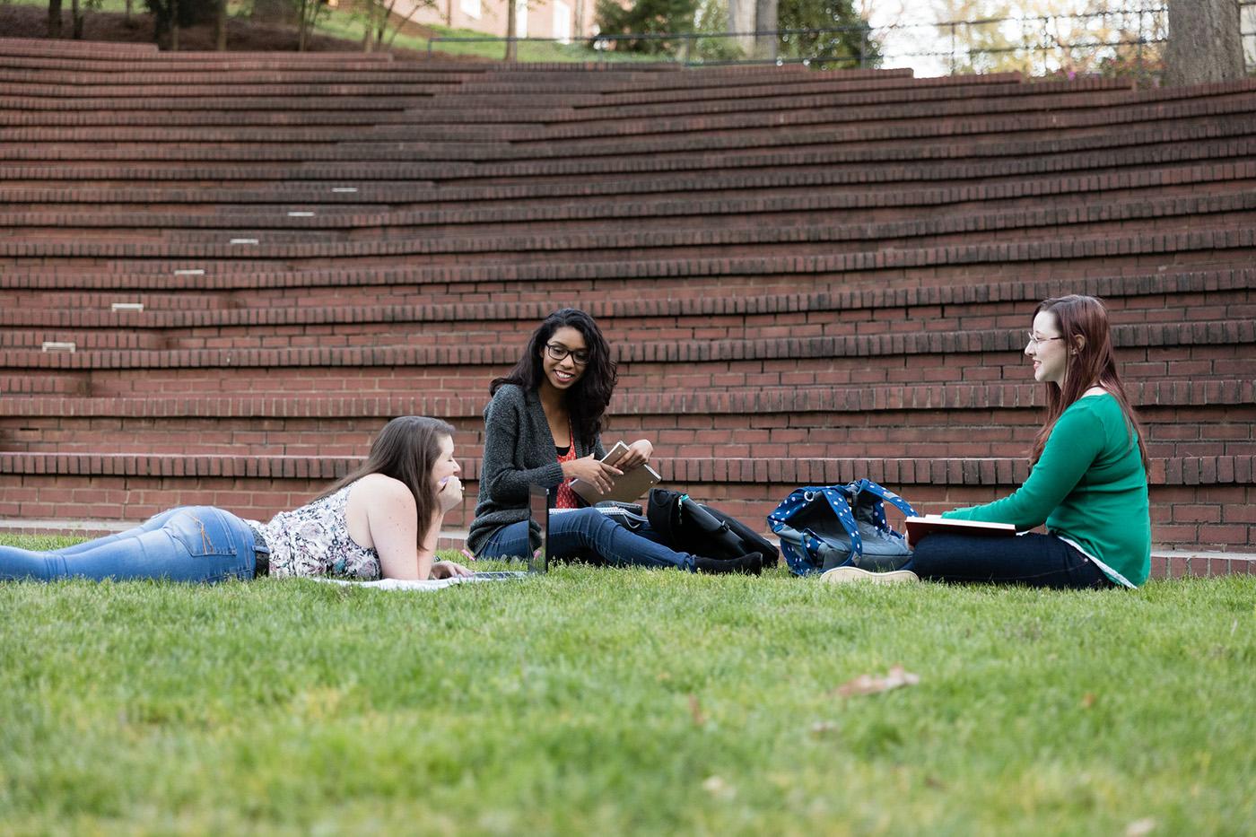 Students relaxing in the May Dell on the campus of Salem College