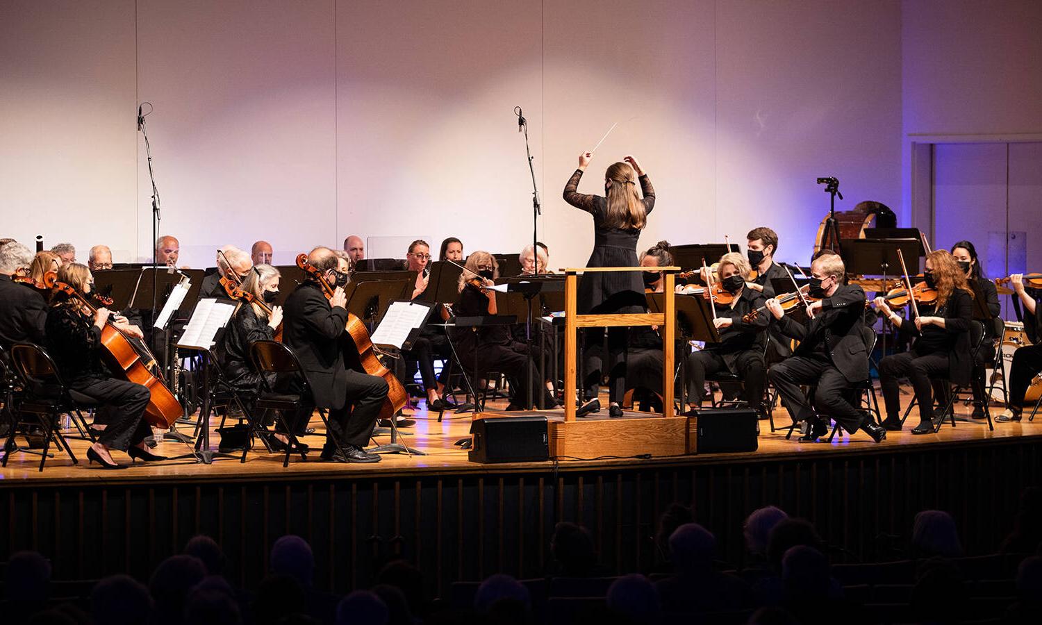 Salem College community orchestra playing while conductor leads